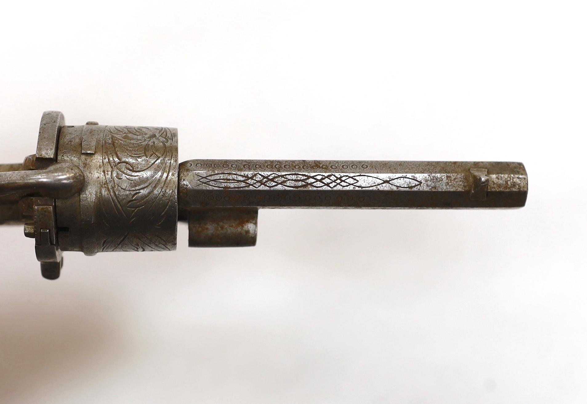 A six shot, 7mm Belgian self cocking pinfire revolver, octagonal barrel, roll engraved frame and cylinder fitted with two piece moulded casein grips